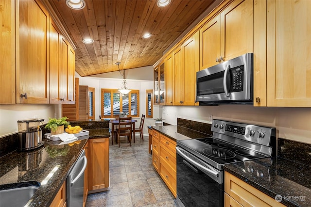 kitchen featuring lofted ceiling, hanging light fixtures, dark stone countertops, appliances with stainless steel finishes, and wood ceiling