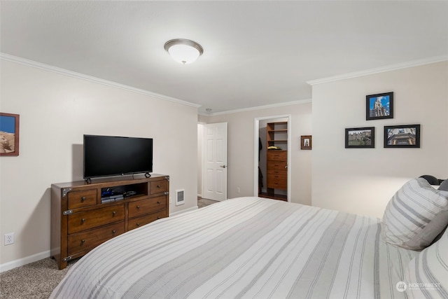 bedroom with a spacious closet, light colored carpet, and ornamental molding