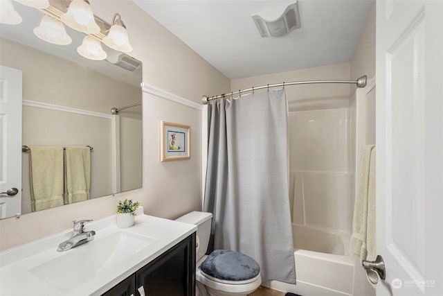 full bathroom with vanity, shower / tub combo, and toilet