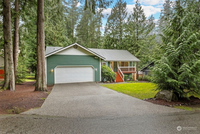 view of front facade featuring covered porch, a front yard, and a garage