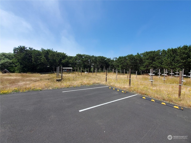 view of vehicle parking with a rural view