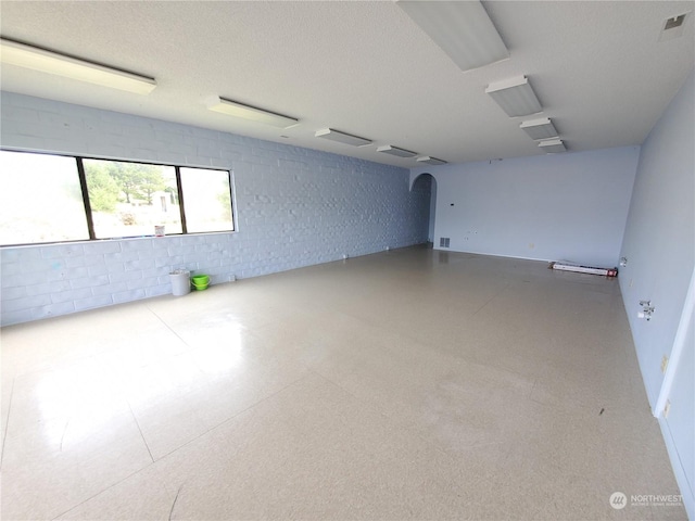 unfurnished room featuring a textured ceiling