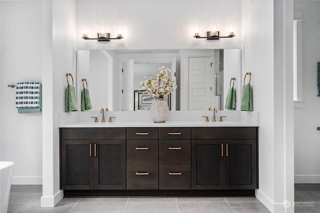 bathroom featuring tile patterned flooring and vanity