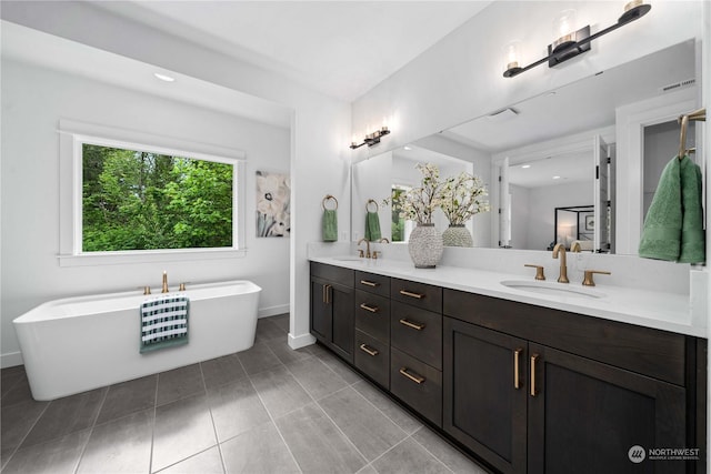 bathroom featuring vanity and a tub to relax in