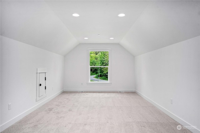 bonus room featuring light carpet and lofted ceiling