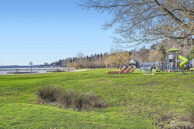 view of yard with a water view and a playground