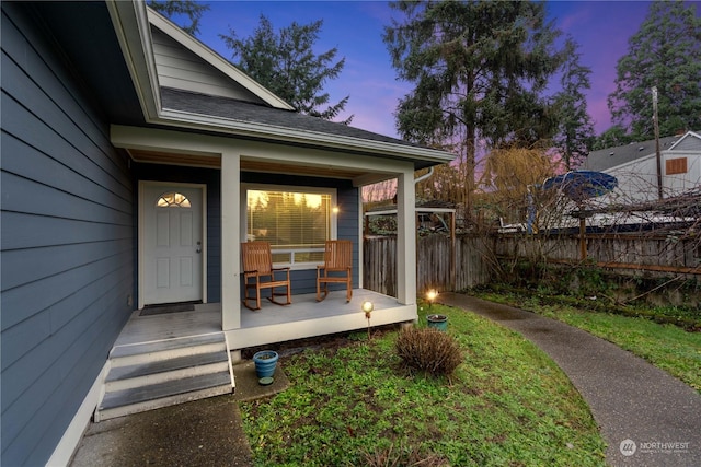 exterior entry at dusk with covered porch