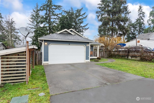 view of front of home with a front yard and a garage