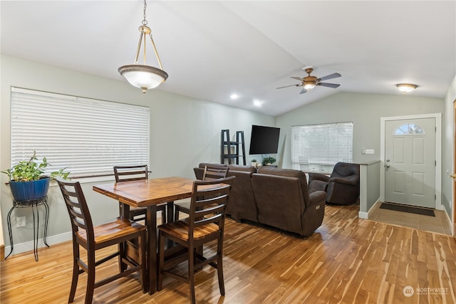 dining area featuring lofted ceiling, ceiling fan, and wood-type flooring