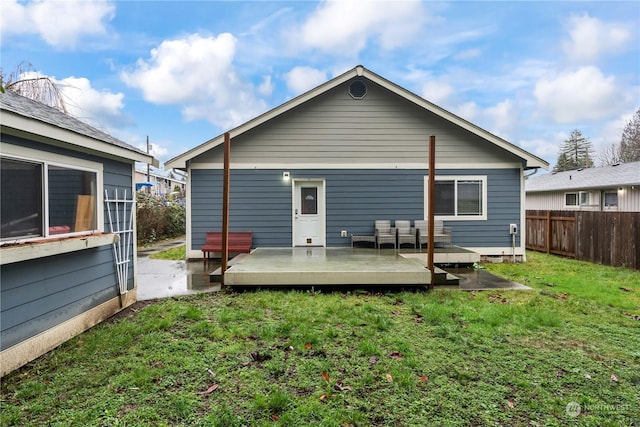 rear view of house with a lawn and a deck