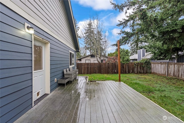 wooden terrace featuring a yard