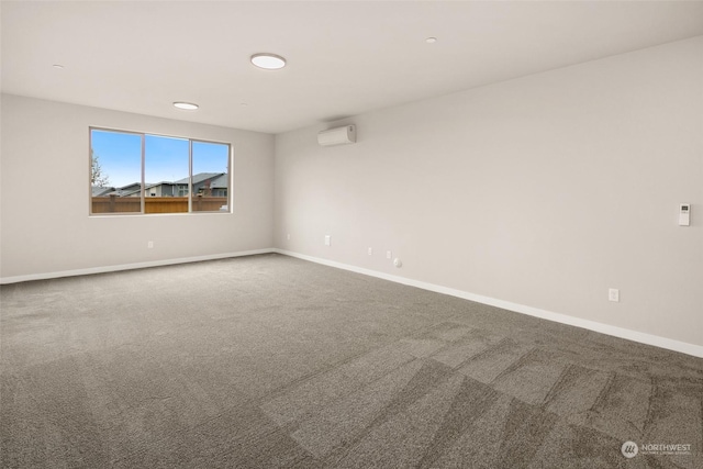 unfurnished room featuring carpet and a wall unit AC