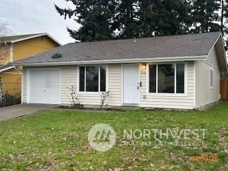 single story home with a front yard and a garage