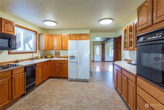 45143 Main St, Concrete, WA 98237 - kitchen featuring black appliances, sink, and a textured ceiling