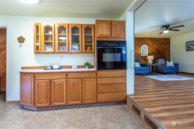 45143 Main St, Concrete, WA 98237 - kitchen with black oven, ceiling fan, and wood walls