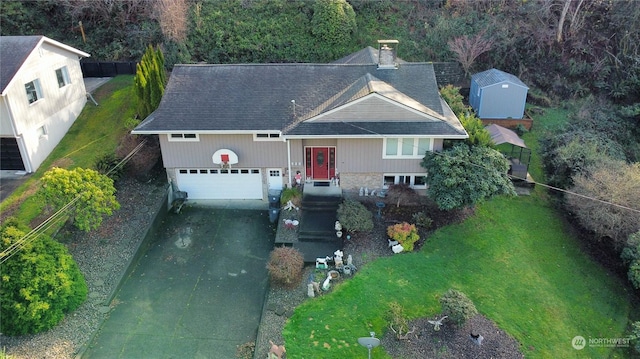 view of front of property with a garage, a shed, and a front yard