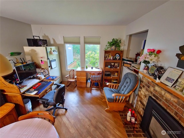 office area with a fireplace and hardwood / wood-style flooring