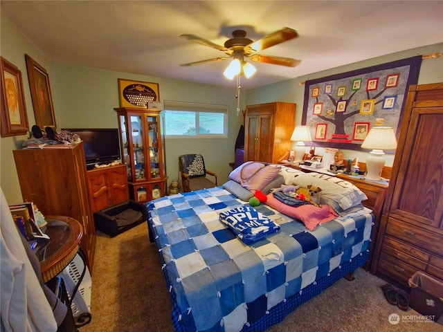 bedroom with ceiling fan and dark carpet