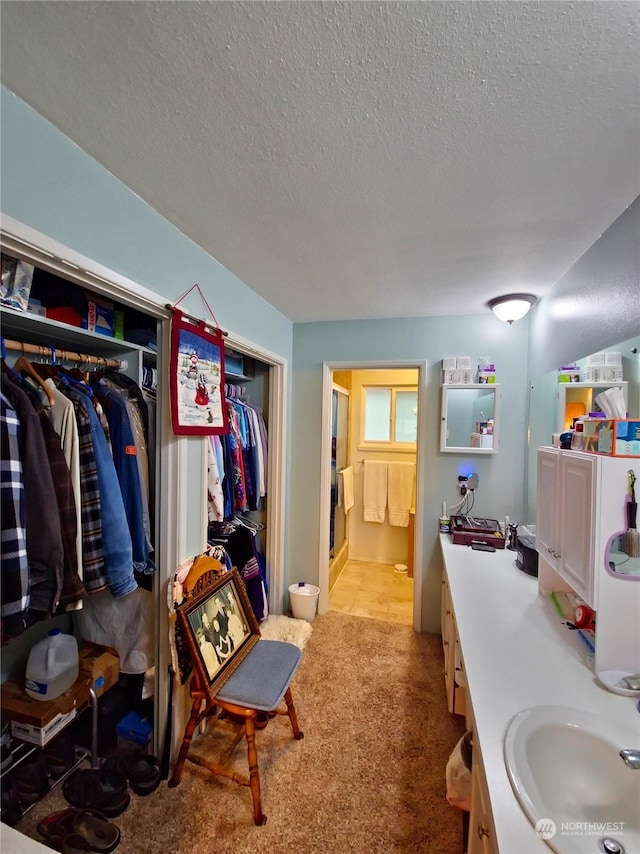 bathroom featuring a textured ceiling and sink