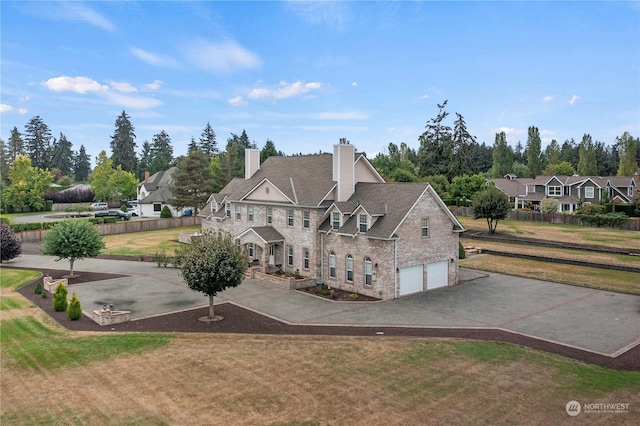 view of front of house with a garage and a front lawn