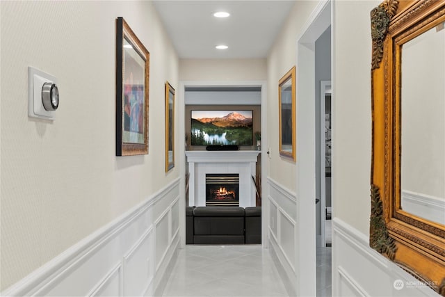 hall featuring light tile patterned floors