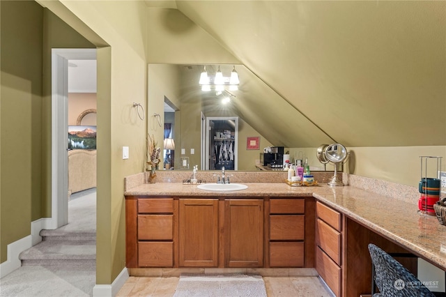 bathroom featuring vanity and vaulted ceiling