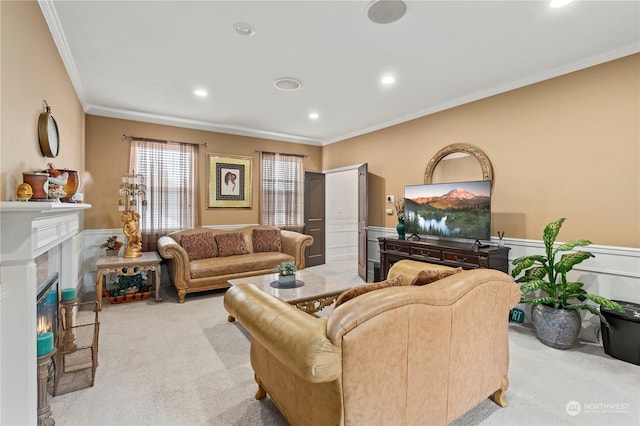 living room with a high end fireplace, light carpet, and ornamental molding