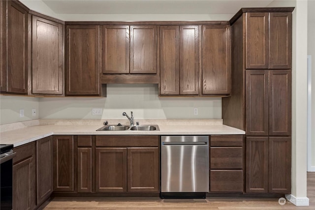 kitchen featuring dark brown cabinets, light hardwood / wood-style flooring, and sink