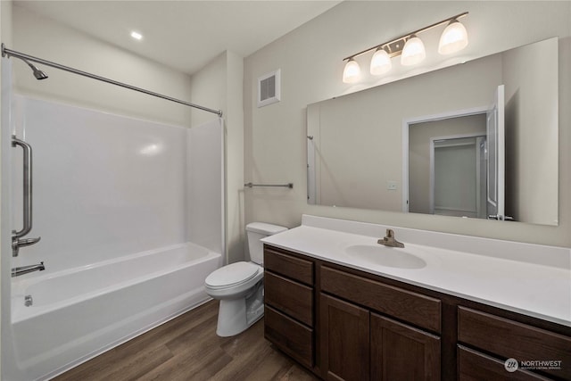 full bathroom with vanity, hardwood / wood-style flooring, shower / bathing tub combination, and toilet