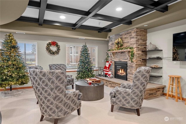 living room featuring beamed ceiling, plenty of natural light, light colored carpet, and a fireplace