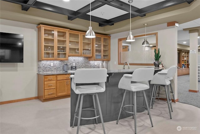 kitchen with light carpet, tasteful backsplash, light stone counters, coffered ceiling, and beam ceiling