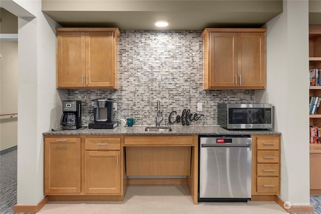 kitchen featuring backsplash, sink, light tile patterned floors, light stone counters, and stainless steel appliances