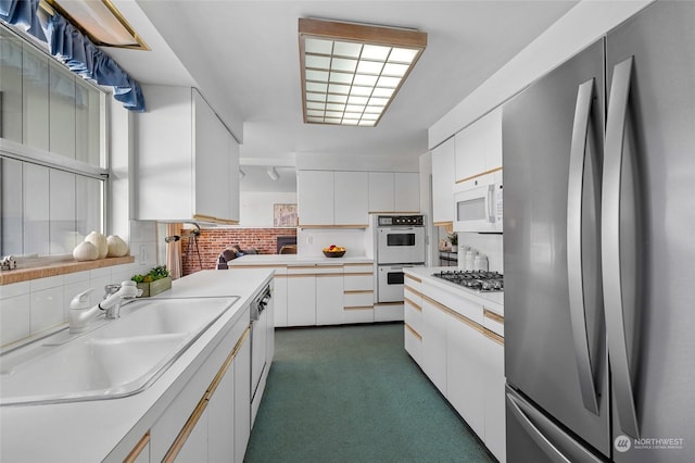 4144 94th Ave SE, Mercer Island, WA 98040 - kitchen with stainless steel appliances, white cabinets, tasteful backsplash, and sink