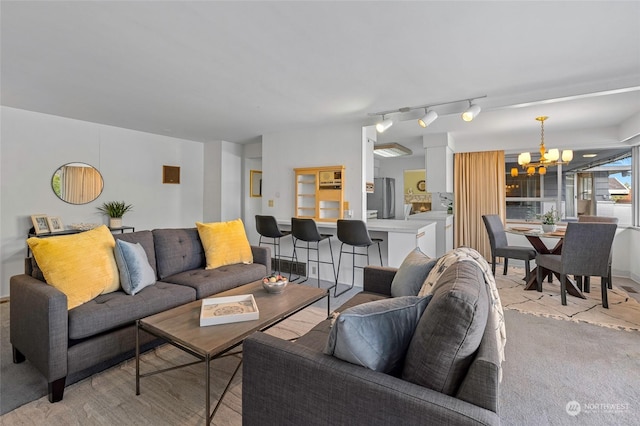 4144 94th Ave SE, Mercer Island, WA 98040 - living room featuring washer / clothes dryer, light colored carpet, a chandelier, and rail lighting