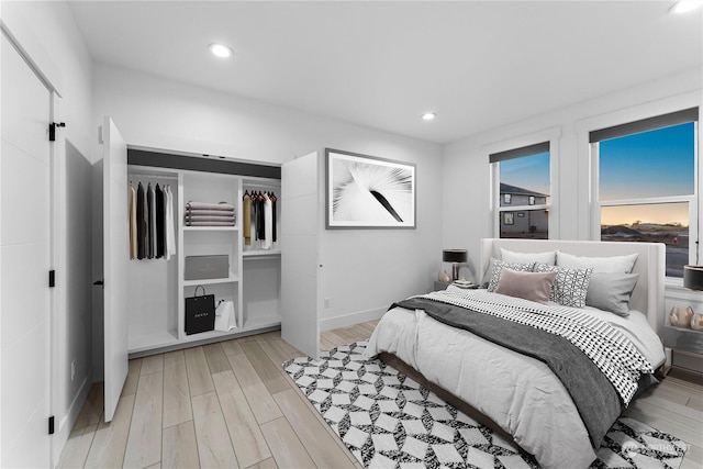 bedroom featuring light wood-type flooring and a closet