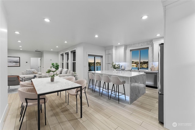 dining room with light hardwood / wood-style floors and sink