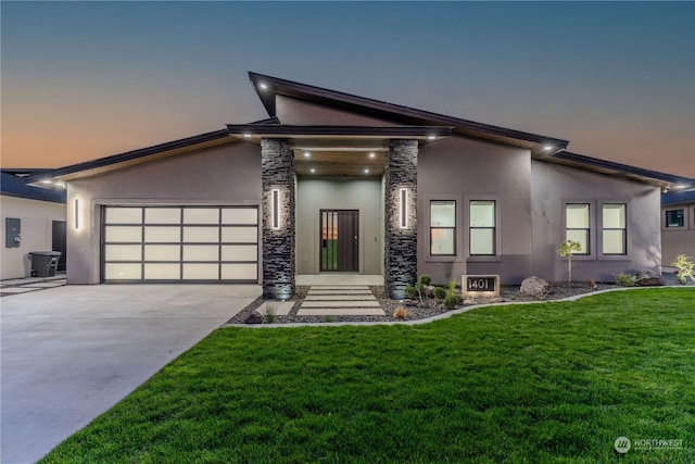 view of front facade with a lawn and a garage