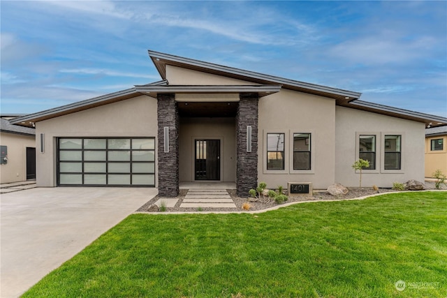 view of front of house featuring a garage and a front yard