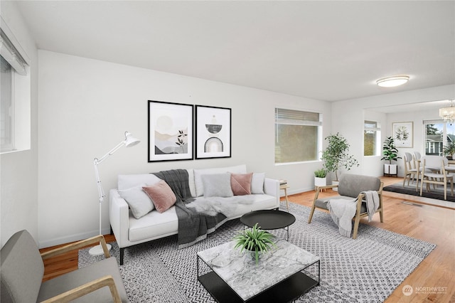 living room with a notable chandelier and hardwood / wood-style flooring