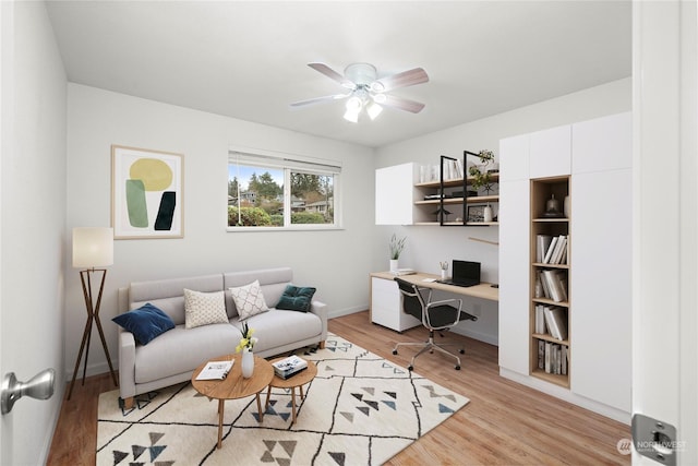 living room with ceiling fan and light wood-type flooring