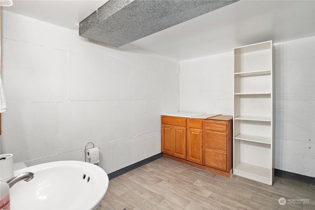 bathroom with hardwood / wood-style flooring and sink