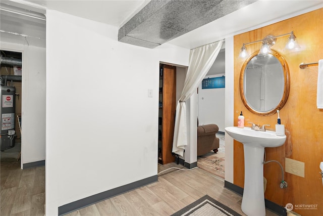 bathroom with hardwood / wood-style flooring and gas water heater