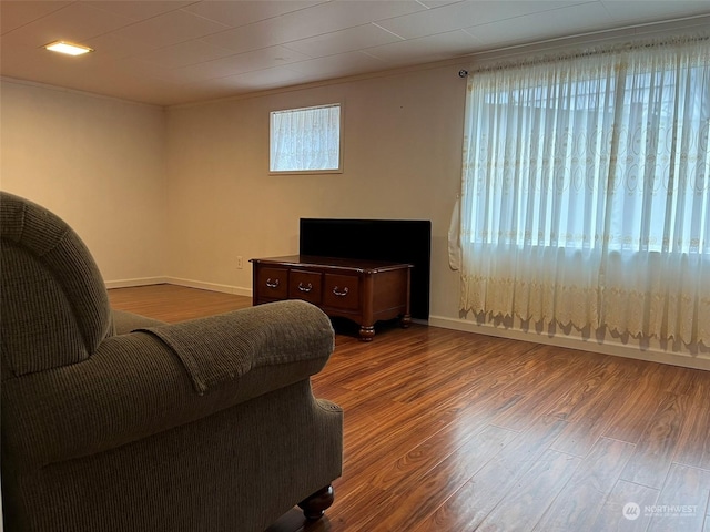 living room featuring crown molding and dark hardwood / wood-style floors