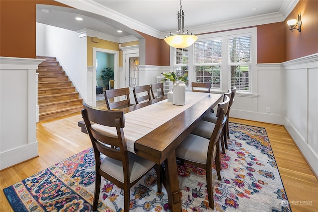 dining room featuring crown molding and light wood-type flooring