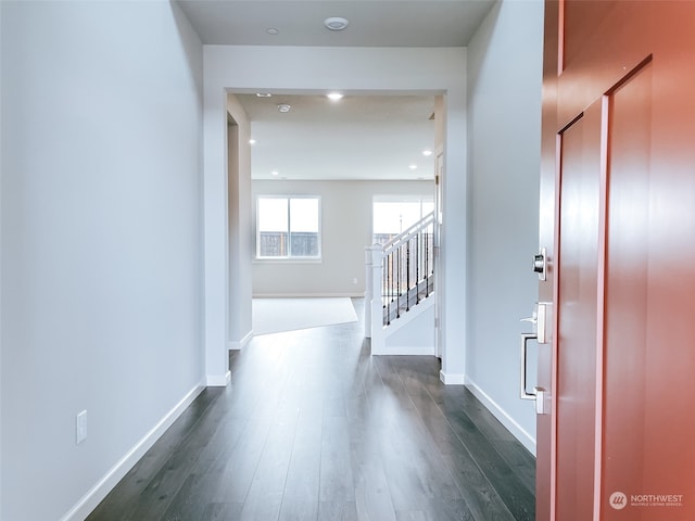 corridor with dark hardwood / wood-style flooring