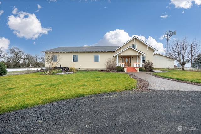 view of front of house featuring covered porch and a front yard