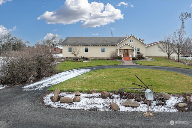 single story home featuring a front lawn and covered porch