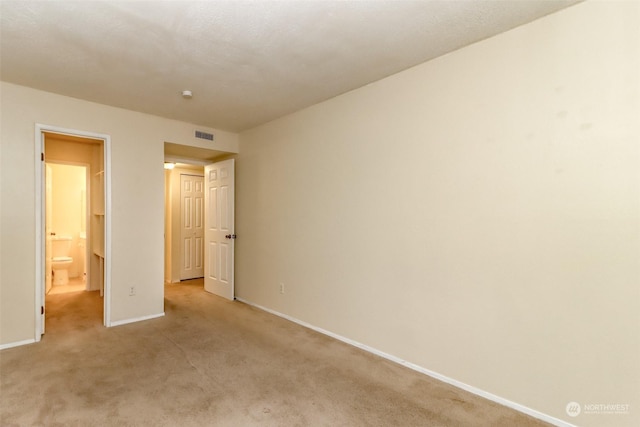 unfurnished bedroom with light colored carpet