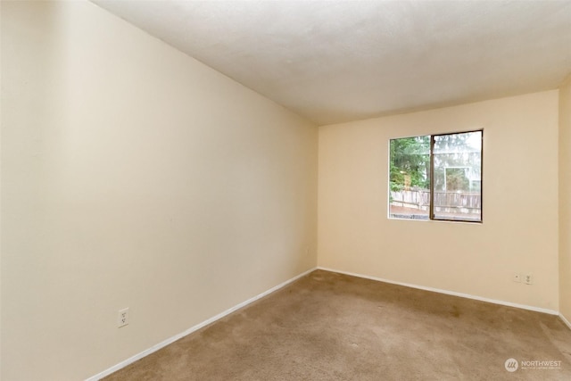 spare room with light colored carpet