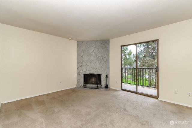 unfurnished living room featuring a fireplace and carpet floors